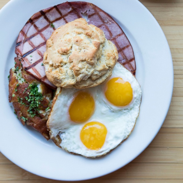 Country Breakfast with sunny side up eggs, grilled ham, hash browns, and a buttermilk biscuit